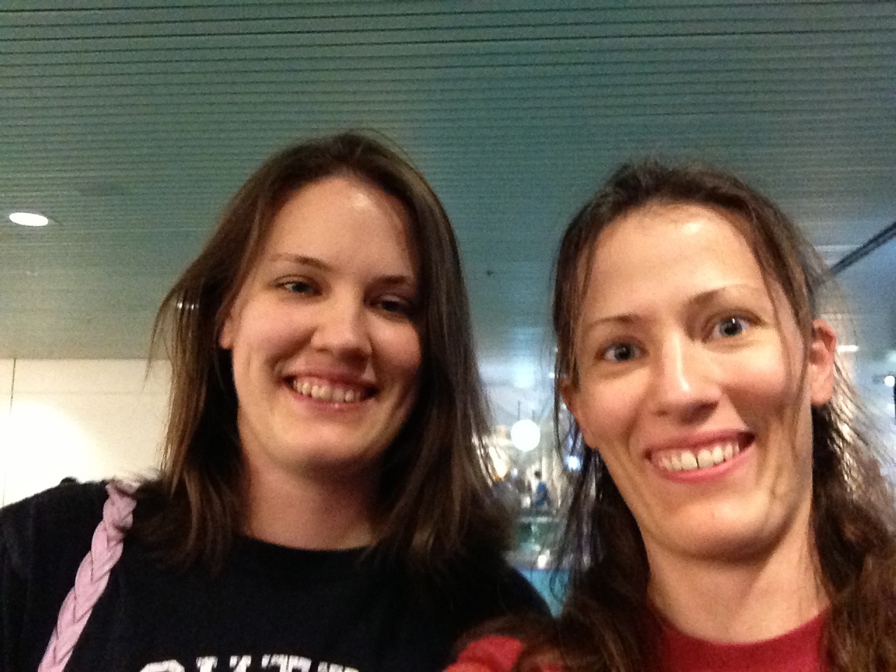 My sis and me, tired, hungry, and a bit bedraggled, but overjoyed to see each other at the airport!